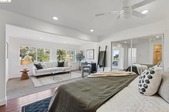 a balcony with wooden floor and outdoor seating