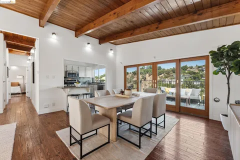 a dining room with furniture and wooden floor
