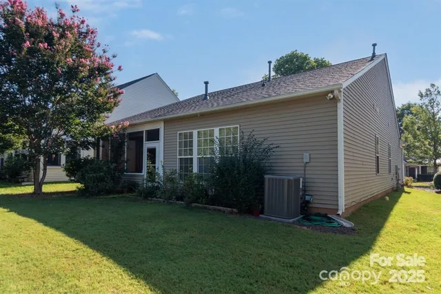a view of a house with pool and garden