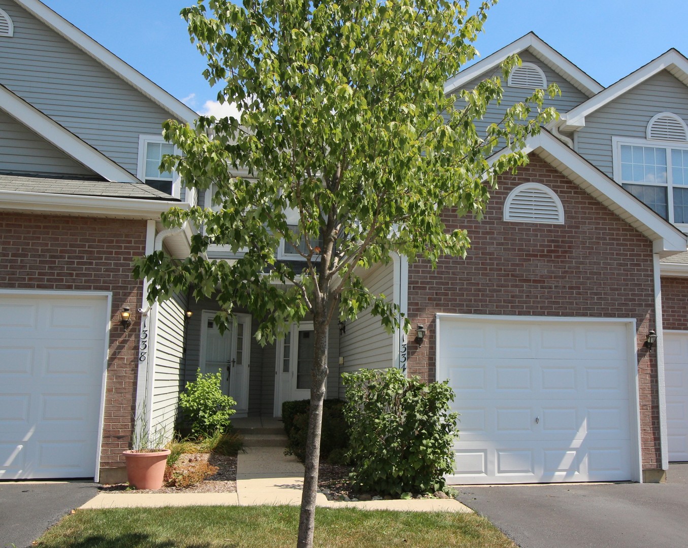 1334 Grandview Court Algonquin, IL 60102 - Photo 3 of 21 a front view of a house with a yard garage and outdoor seating
