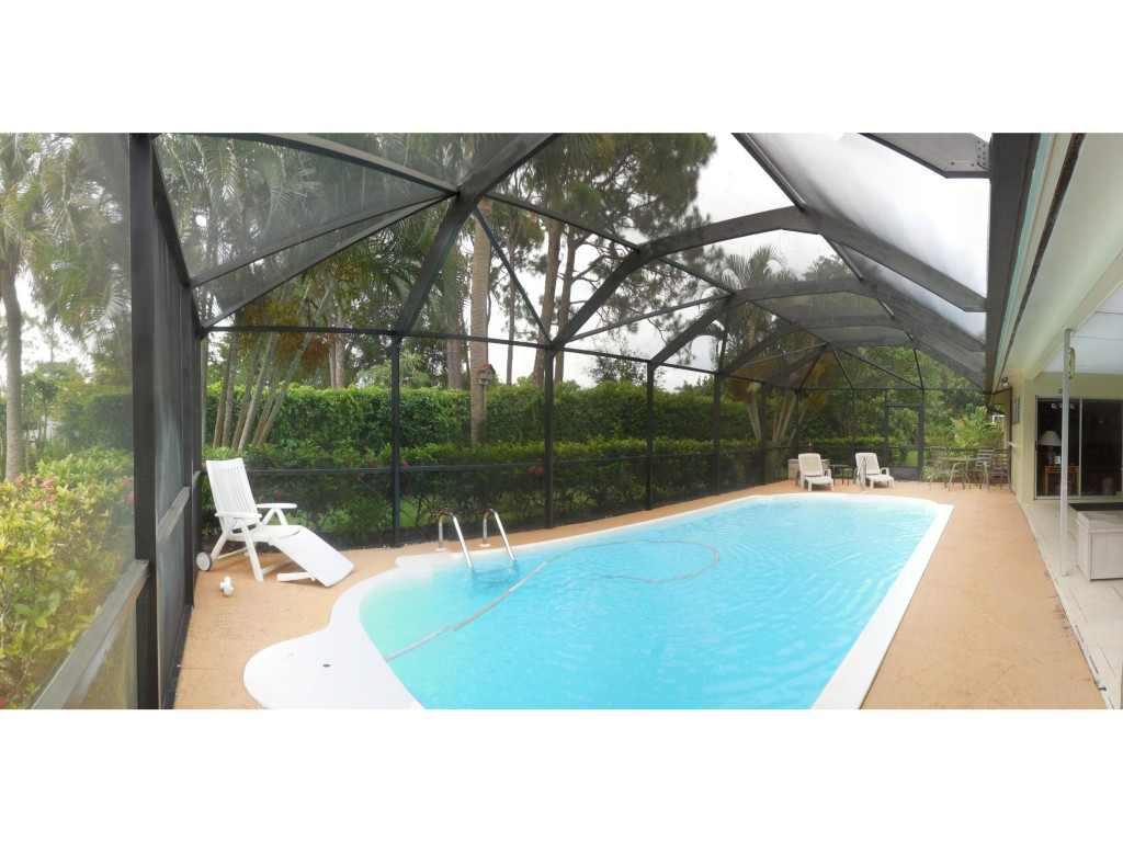 a swimming pool with outdoor seating and yard