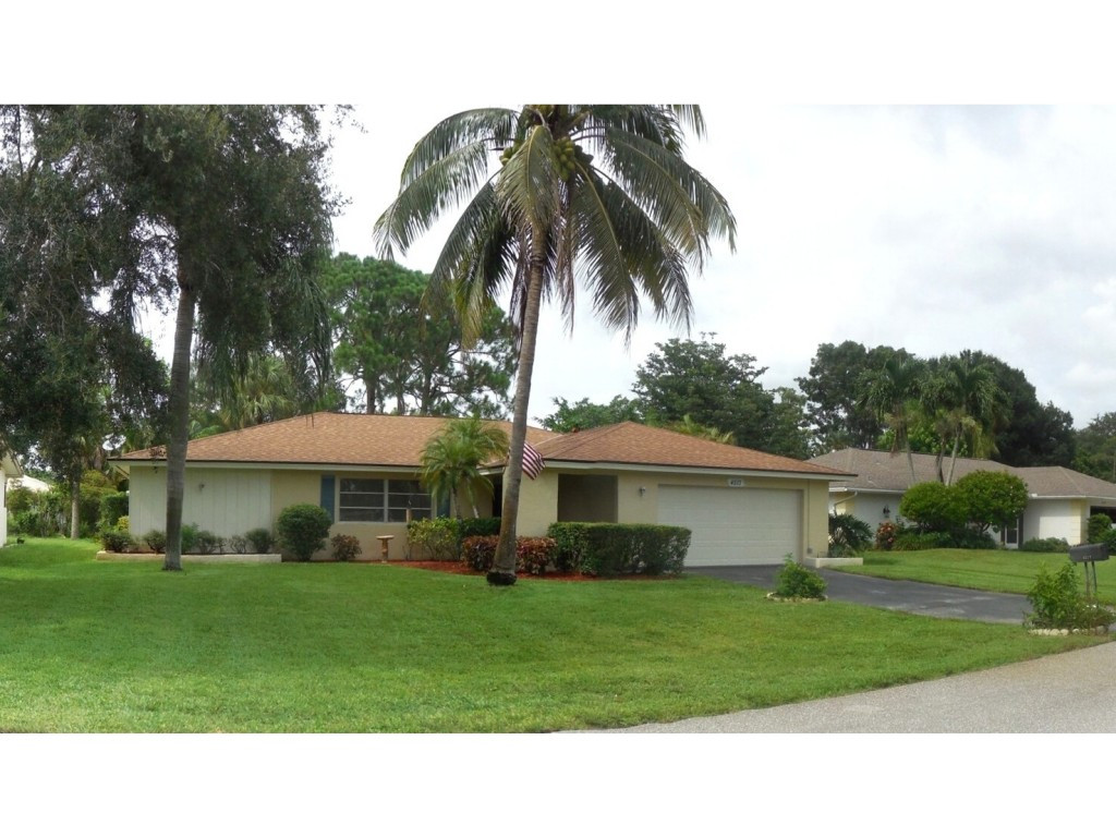 4517 Parrot Avenue Naples, FL 34104 - Photo 2 of 13 a black and white house with a garden
