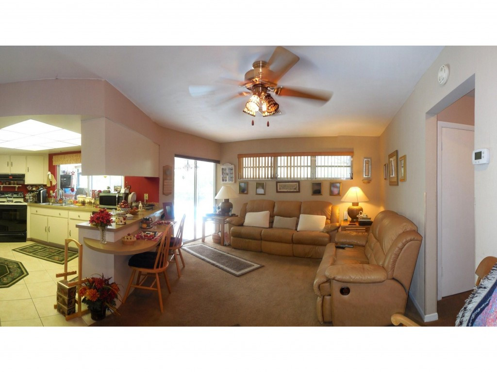 4517 Parrot Avenue Naples, FL 34104 - Photo 7 of 13 a living room with furniture and a large window