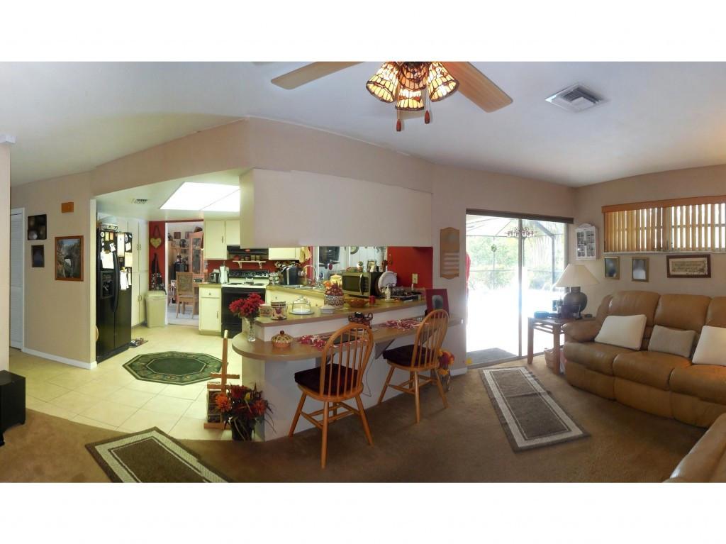 4517 Parrot Avenue Naples, FL 34104 - Photo 8 of 13 a living room with furniture and a large window