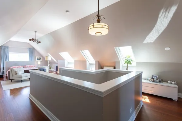 a view of living room with granite countertop furniture a chandelier and wooden floor