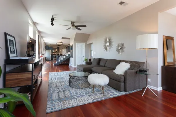 a living room with furniture and wooden floor