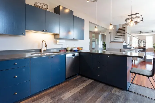 a kitchen with a sink a window and cabinets