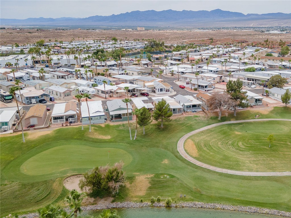 2000 Ramar Road, Unit 612 Bullhead City, AZ 86442 - Photo 49 of 77 Aerial perspective of suburban area featuring a mountain backdrop and a golf club