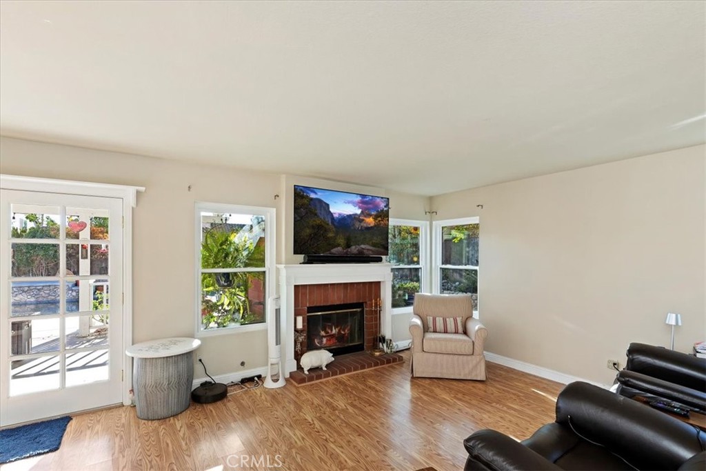 20637 Mesa Oak Drive Riverside, CA 92508 - Photo 27 of 66 a living room with furniture a flat screen tv and a fireplace