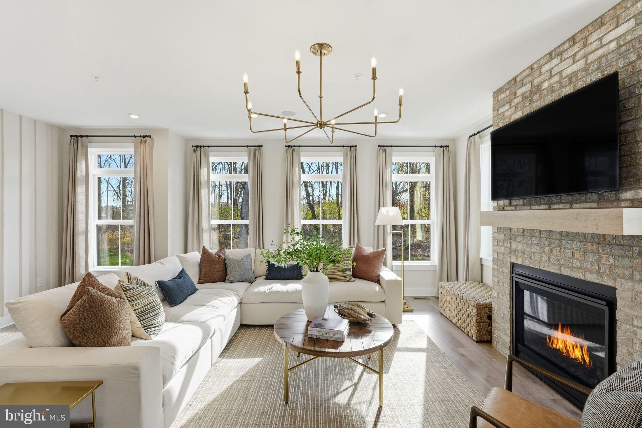 405 Pennybrook Court, Unit 3 Flourtown, PA 19031 - Photo 14 of 31 a living room with furniture a fireplace and a flat screen tv