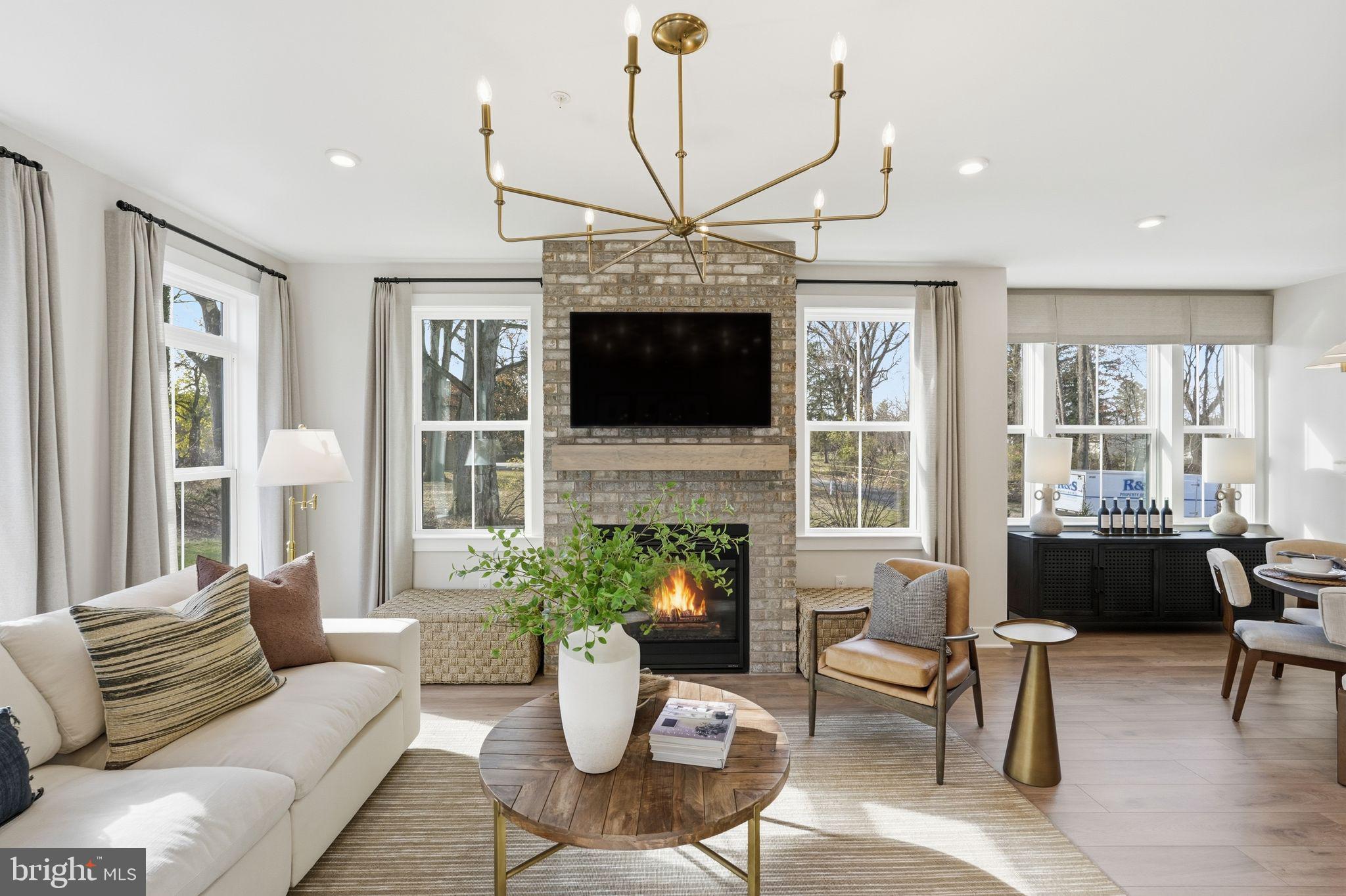 405 Pennybrook Court, Unit 3 Flourtown, PA 19031 - Photo 15 of 31 a living room with furniture a fireplace and a chandelier