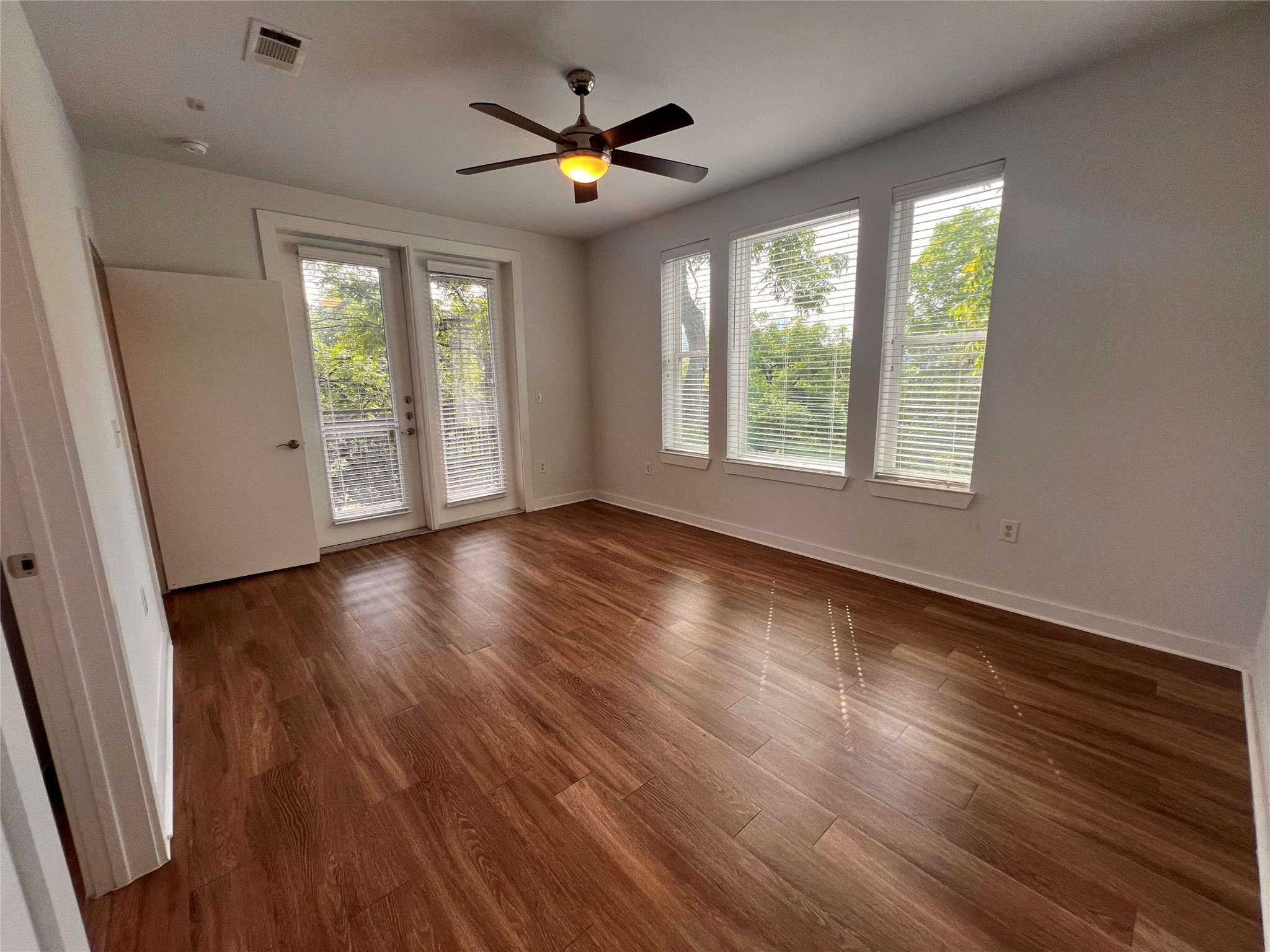 1900 Barton Springs Road, Unit 4041 Austin, TX 78704 - Photo 7 of 35 a view of an empty room with wooden floor and a window