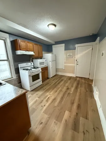 a kitchen with a stove a sink and a refrigerator