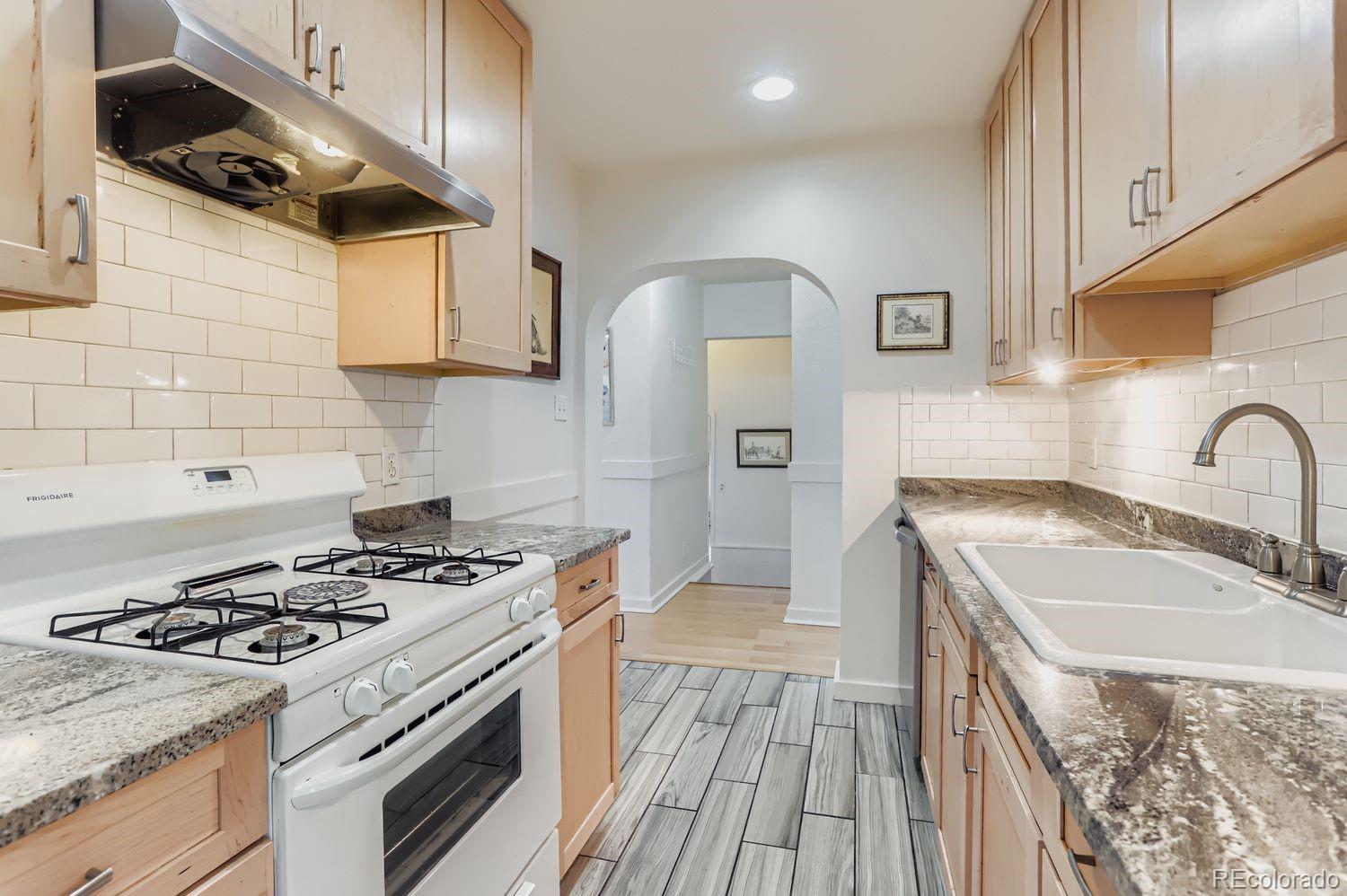 1010 9th Street Boulder, CO 80302 - Photo 13 of 28 a kitchen with stainless steel appliances a sink a stove and cabinets