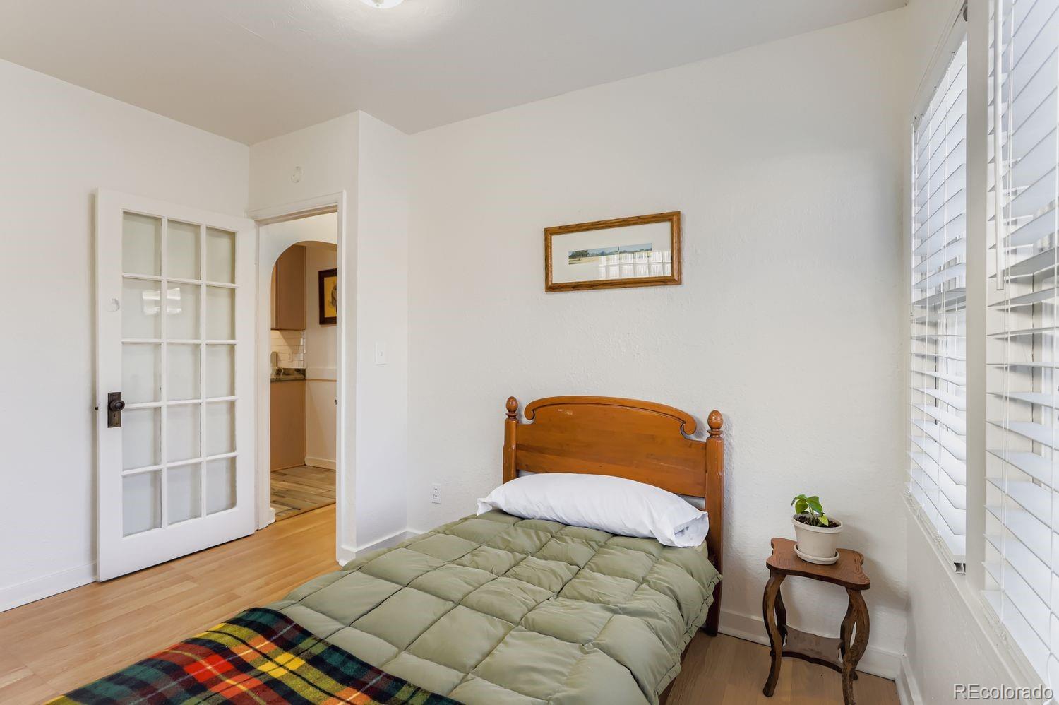 1010 9th Street Boulder, CO 80302 - Photo 16 of 28 a bedroom with a bed and wooden floor