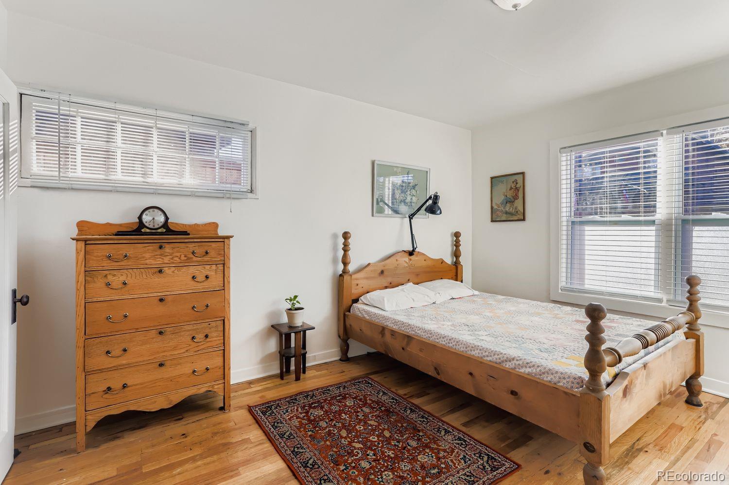 1010 9th Street Boulder, CO 80302 - Photo 18 of 28 a bedroom with a bed and wooden floor