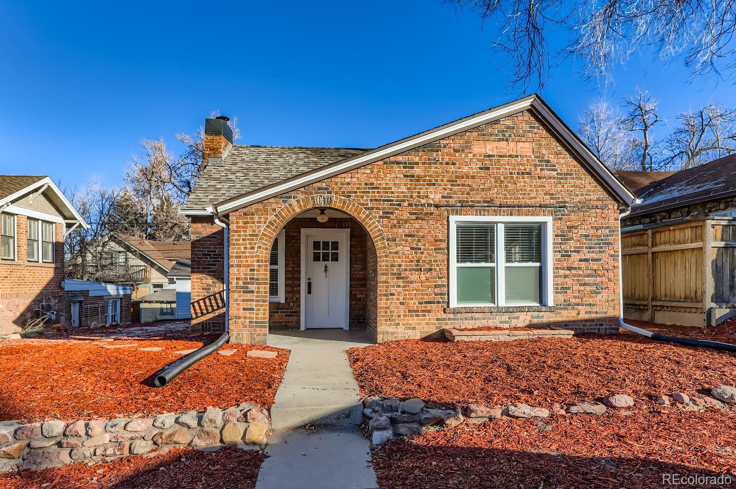 1010 9th Street Boulder, CO 80302 - Photo 2 of 28 a front view of a house with a yard