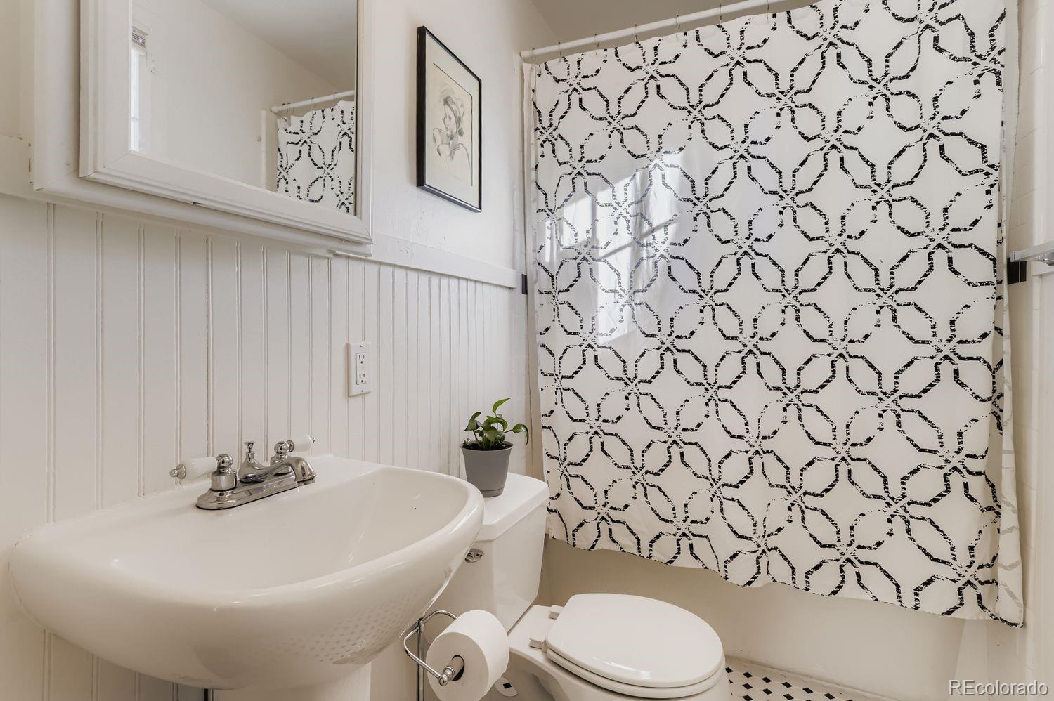 1010 9th Street Boulder, CO 80302 - Photo 21 of 28 a bathroom with a white toilet sitting next to a white wall