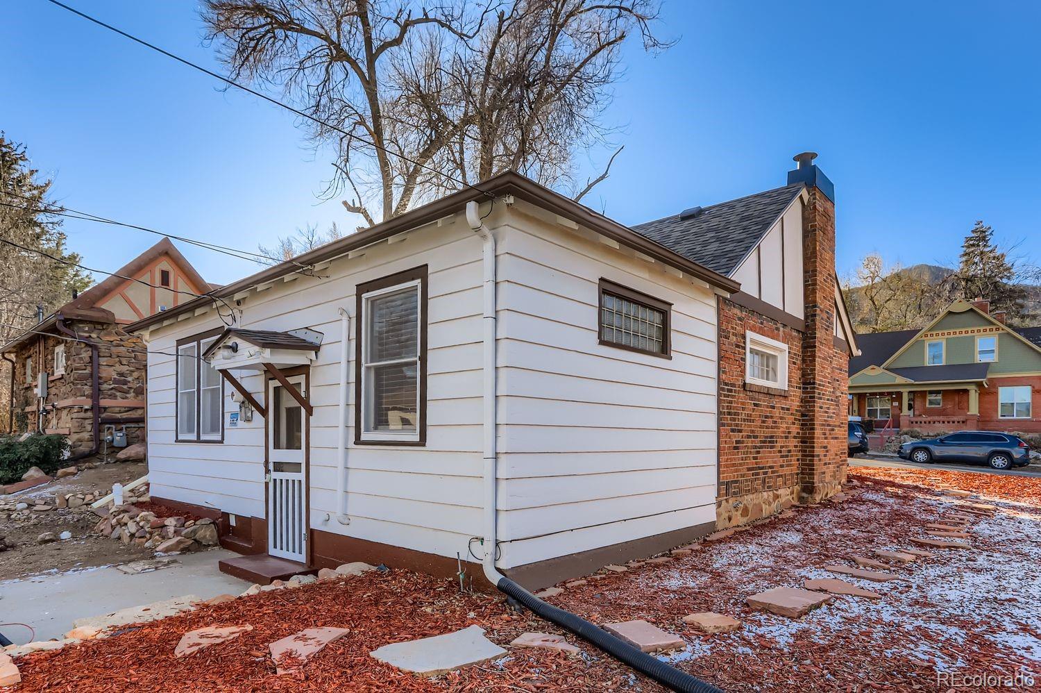 1010 9th Street Boulder, CO 80302 - Photo 26 of 28 a front view of a house with a yard