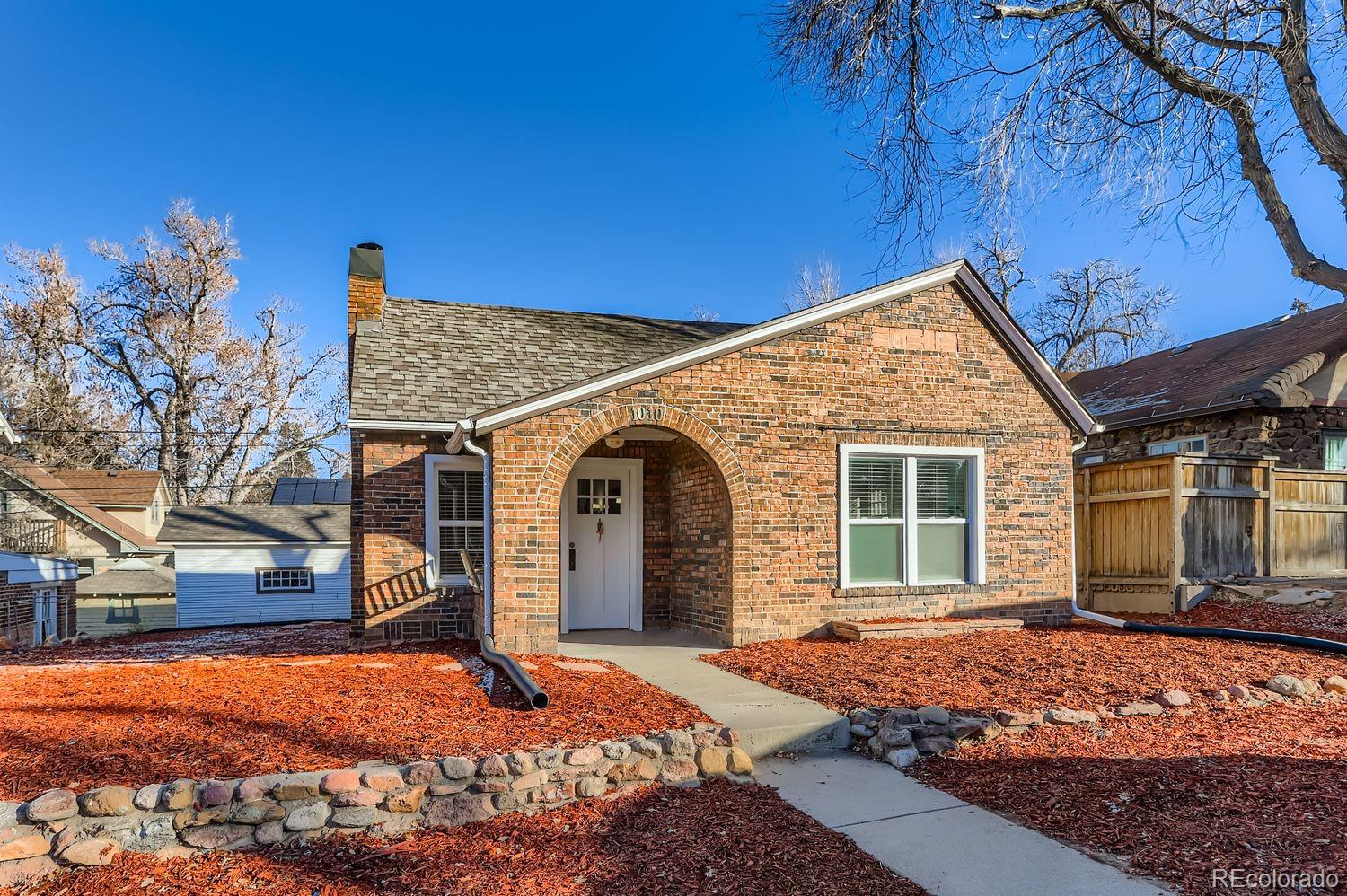 1010 9th Street Boulder, CO 80302 - Photo 4 of 28 a front view of a house with a yard