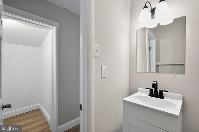 a bathroom with a sink toilet and mirror