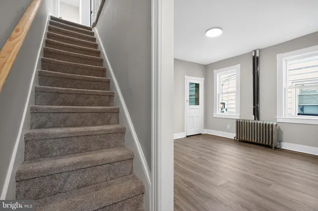 a view of an entryway with wooden floor and door