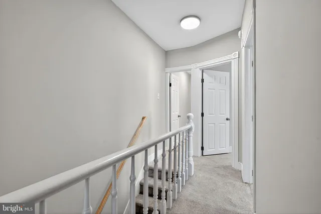 a view of a hallway with wooden floor and entryway