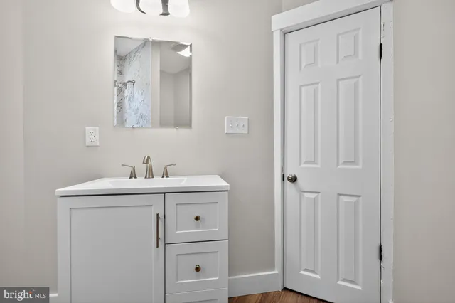 a view of bathroom with sink mirror and