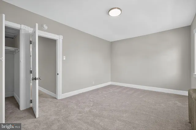 an empty room with closet area
