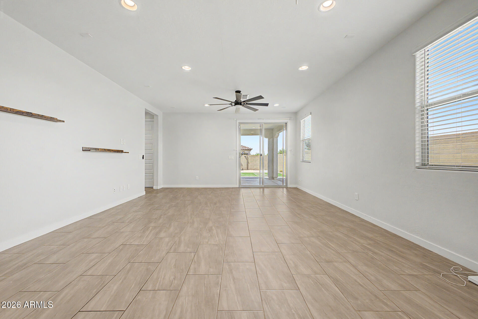 23080 East Stacey Road Queen Creek, AZ 85142 - Photo 13 of 42 a view of empty room with wooden floor and fan
