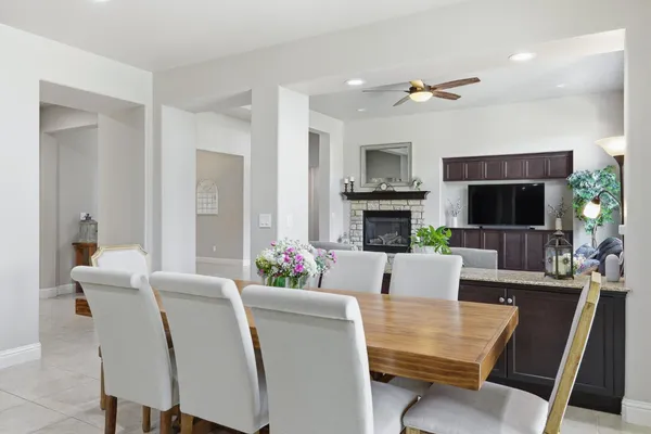 a kitchen with stainless steel appliances granite countertop a table and chairs