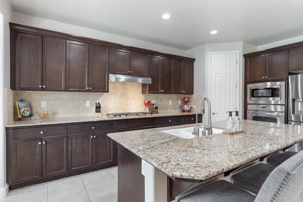 a view of a living room a flat screen tv and windows in a room