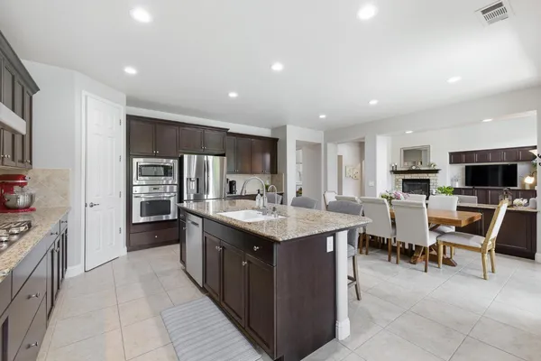 a spacious bathroom with a granite countertop double vanity sink a bathtub and shower