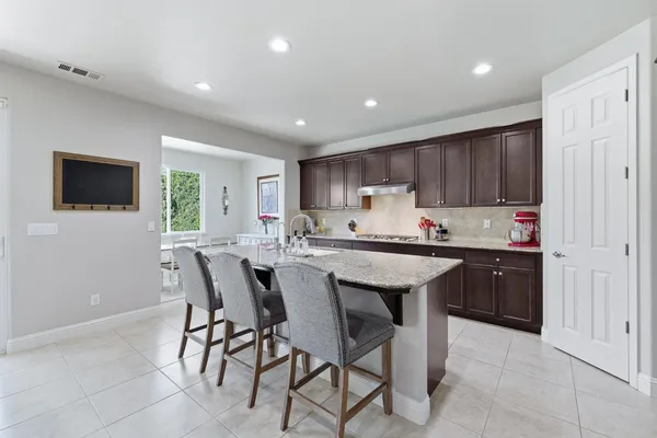 a bathroom with a tub a double vanity sink and mirror