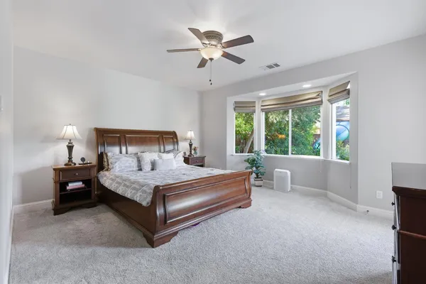 a bedroom with a bed and a desk