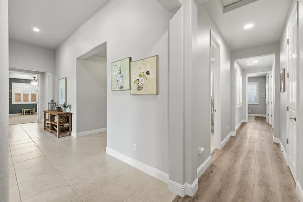 a bedroom with furniture and a large window