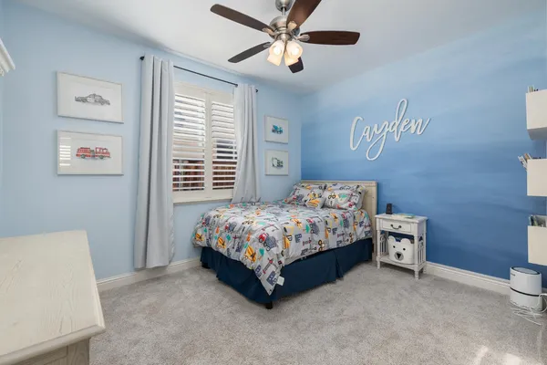 a view of a workspace with furniture and a bookshelf