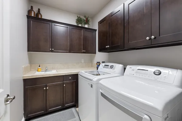 a view of a swimming pool with a patio and a yard