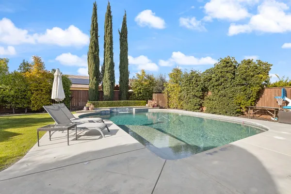 a view of a house with a backyard