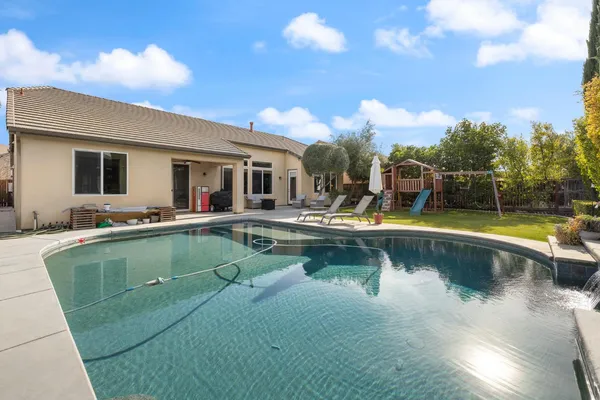 a view of a house with swimming pool and porch