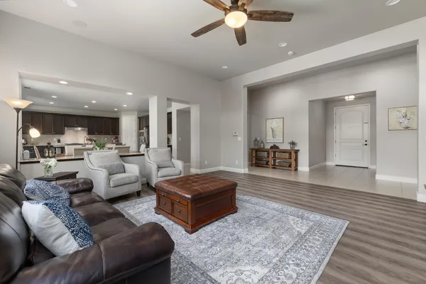 a living room with furniture large window and a fireplace