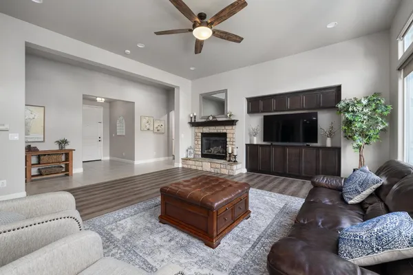 a living room with furniture fireplace and flat screen tv