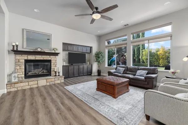 a bathroom with a granite countertop sink and a toilet