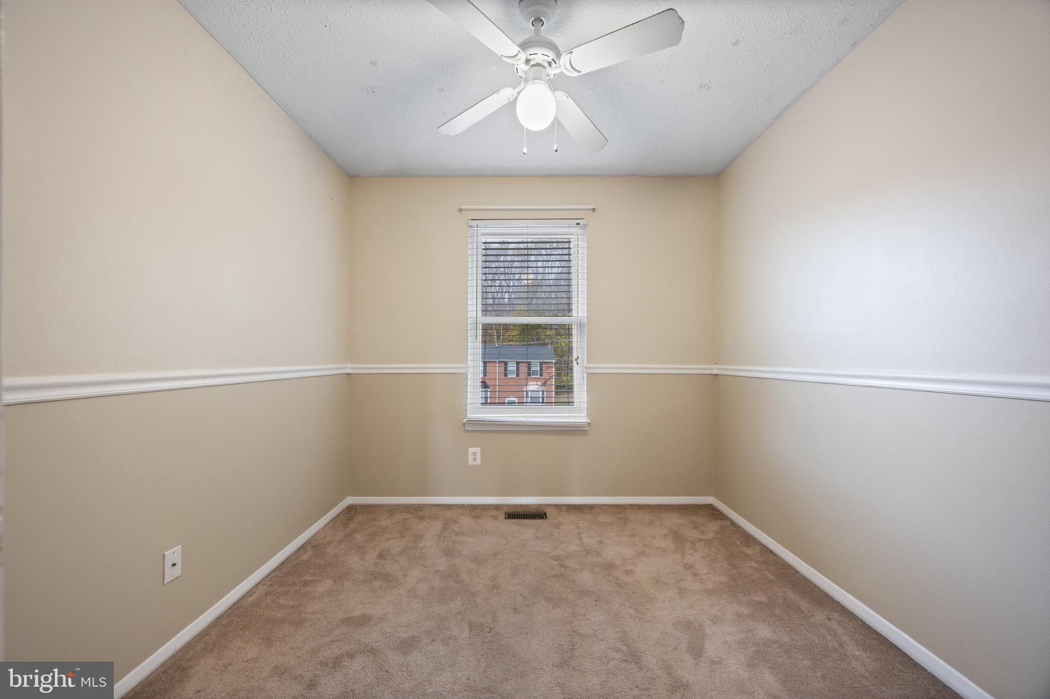 13 Sylvanhurst Court Baltimore, MD 21236 - Photo 24 of 35 an empty room with a window and a fan