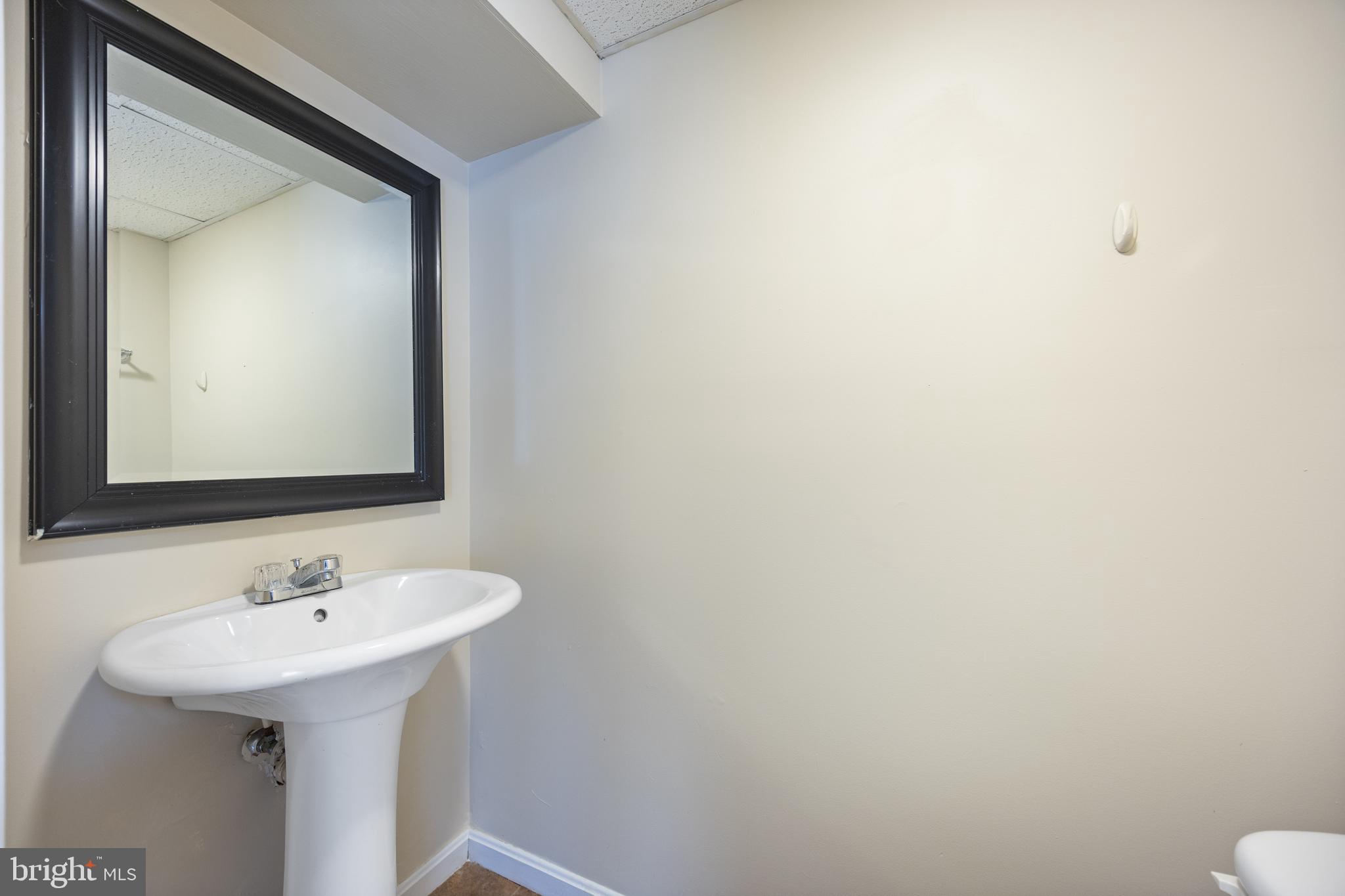13 Sylvanhurst Court Baltimore, MD 21236 - Photo 32 of 35 a bathroom with a sink and a mirror