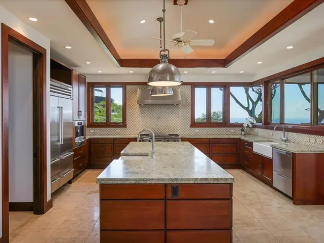 a kitchen with stainless steel appliances granite countertop a stove a sink and a microwave
