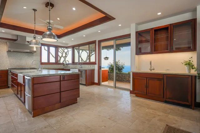 a kitchen with stainless steel appliances granite countertop a stove and a sink