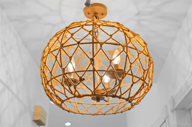 a view of a room with a chandelier and wooden floor