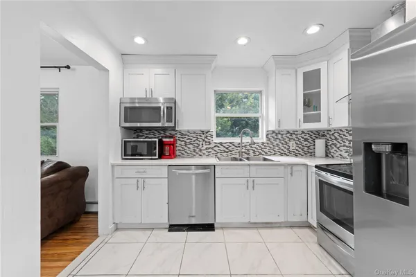 a kitchen with granite countertop cabinets stainless steel appliances and a sink