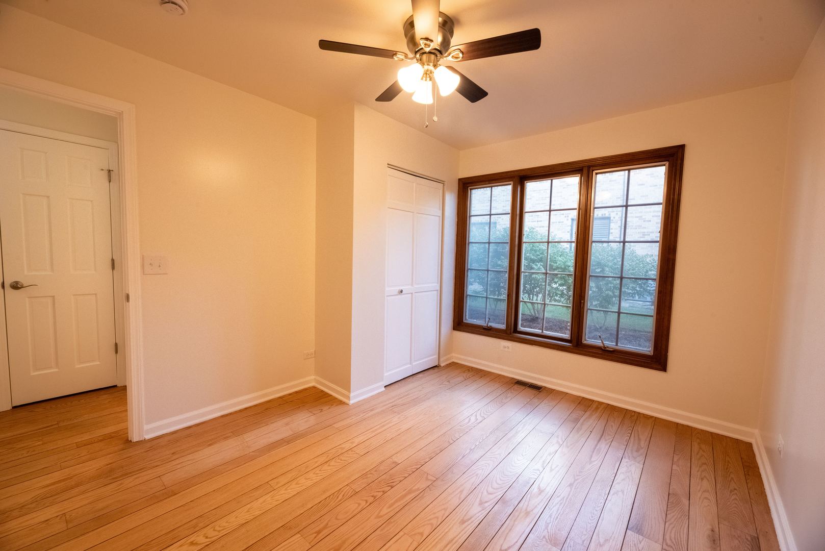 3021 35th Street Oak Brook, IL 60523 - Photo 16 of 32 a view of an empty room with wooden floor and a window